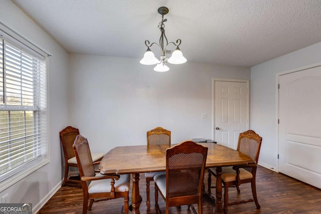 8166 N Pine Cone Dr, Villa Rica, GA 30180 - dining area with a textured ceiling, baseboards, a chandelier, and dark wood finished floors