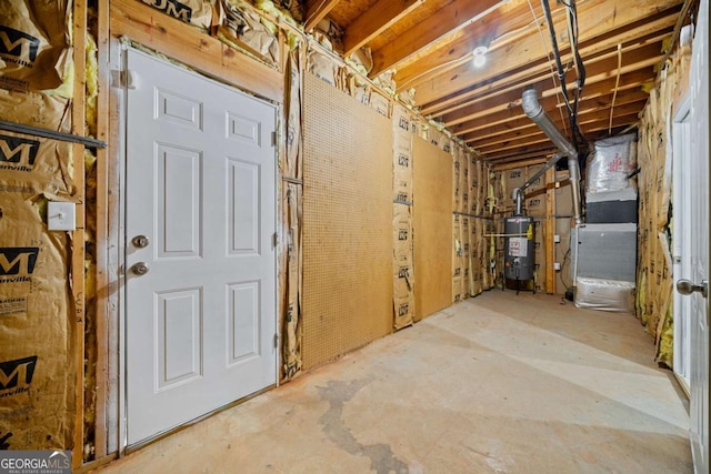 unfinished below grade area featuring water heater and heating unit