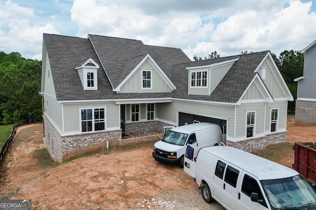 3754 Cheyenne Ln, Jefferson, GA 30549 - view of front of home featuring roof with shingles, brick siding, a garage, and board and batten siding