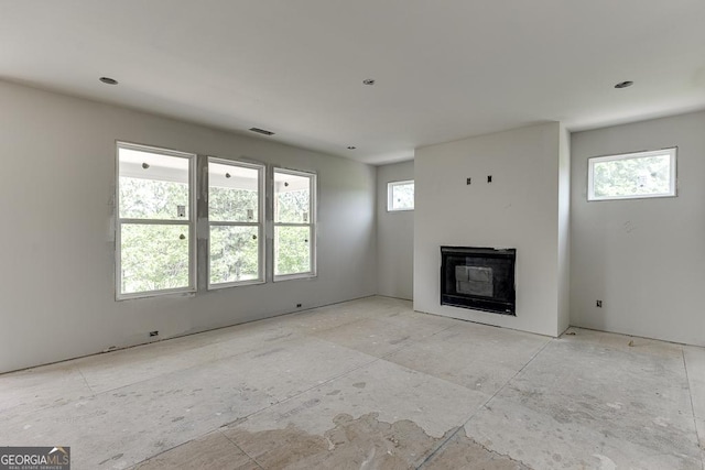 3748 Cheyenne Ln, Jefferson, GA 30549 - unfurnished living room with plenty of natural light and a glass covered fireplace