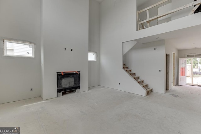 3787 Cheyenne Ln, Jefferson, GA 30549 - unfurnished living room featuring a high ceiling and stairway