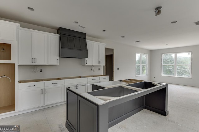 3787 Cheyenne Ln, Jefferson, GA 30549 - kitchen with a kitchen island, white cabinetry, premium range hood, and recessed lighting
