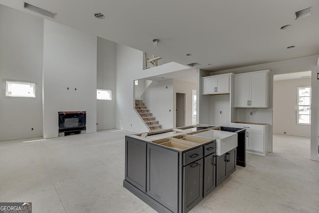 3787 Cheyenne Ln, Jefferson, GA 30549 - kitchen featuring a sink, white cabinets, and a center island with sink