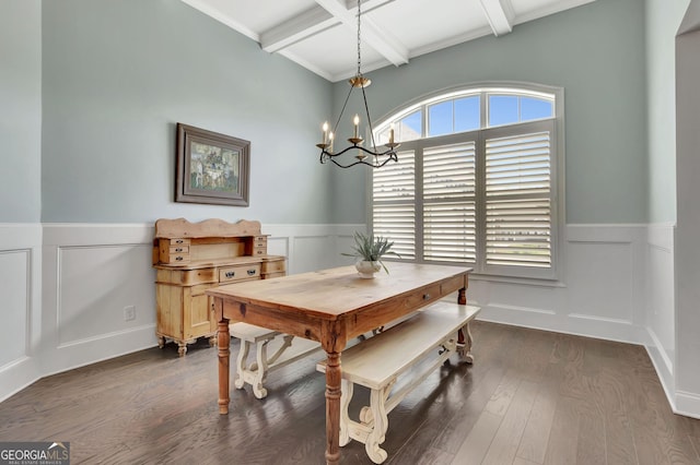 dining space featuring an inviting chandelier, a decorative wall, beamed ceiling, and wainscoting