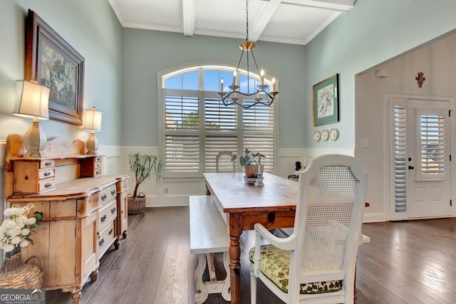 dining room with beamed ceiling, an inviting chandelier, wainscoting, and dark wood finished floors