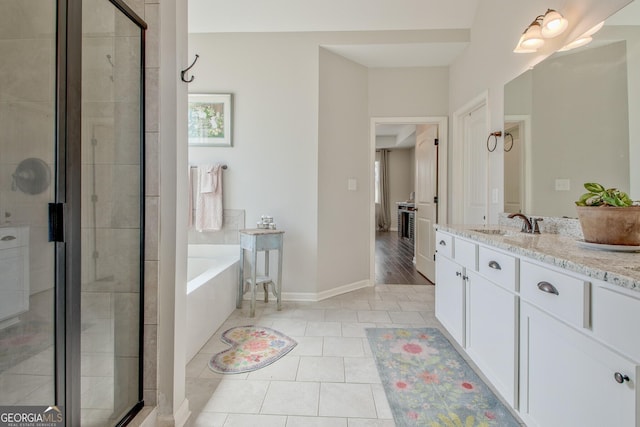 full bath featuring vanity, tile patterned floors, baseboards, a shower stall, and a bath