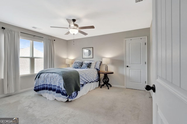 carpeted bedroom featuring baseboards, ceiling fan, and visible vents
