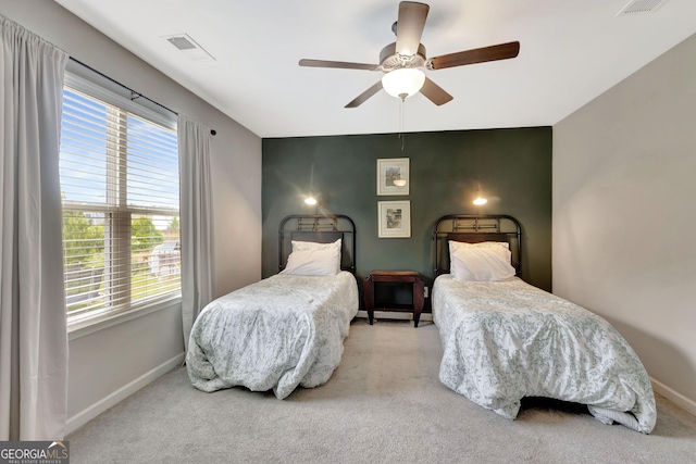 bedroom with baseboards, multiple windows, and visible vents