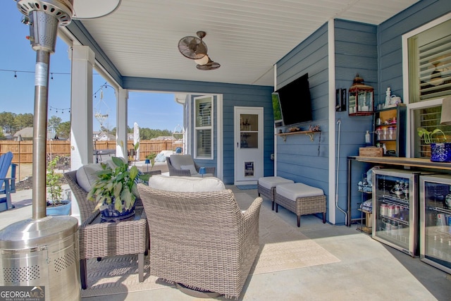view of patio with fence, beverage cooler, and outdoor lounge area