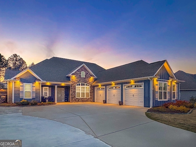view of front facade with a garage, board and batten siding, driveway, and stone siding