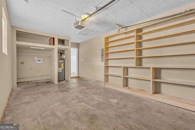 garage featuring electric water heater and a garage door opener