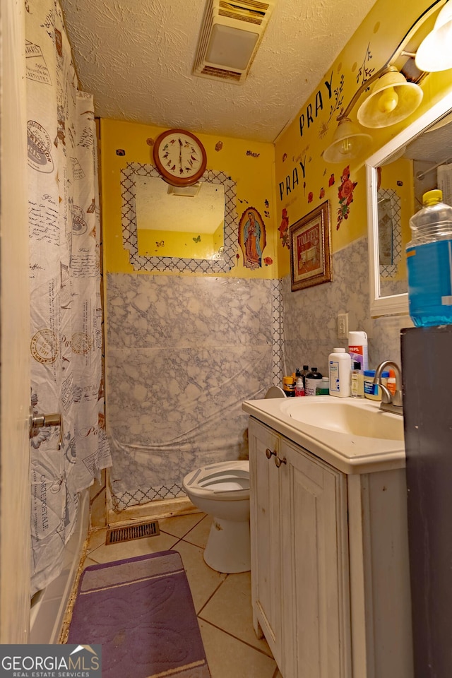 549 N Peter St, Athens, GA 30601 - bathroom with toilet, a textured ceiling, wallpapered walls, tile patterned floors, and visible vents