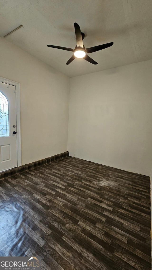 unfurnished room with dark wood-style floors and a ceiling fan