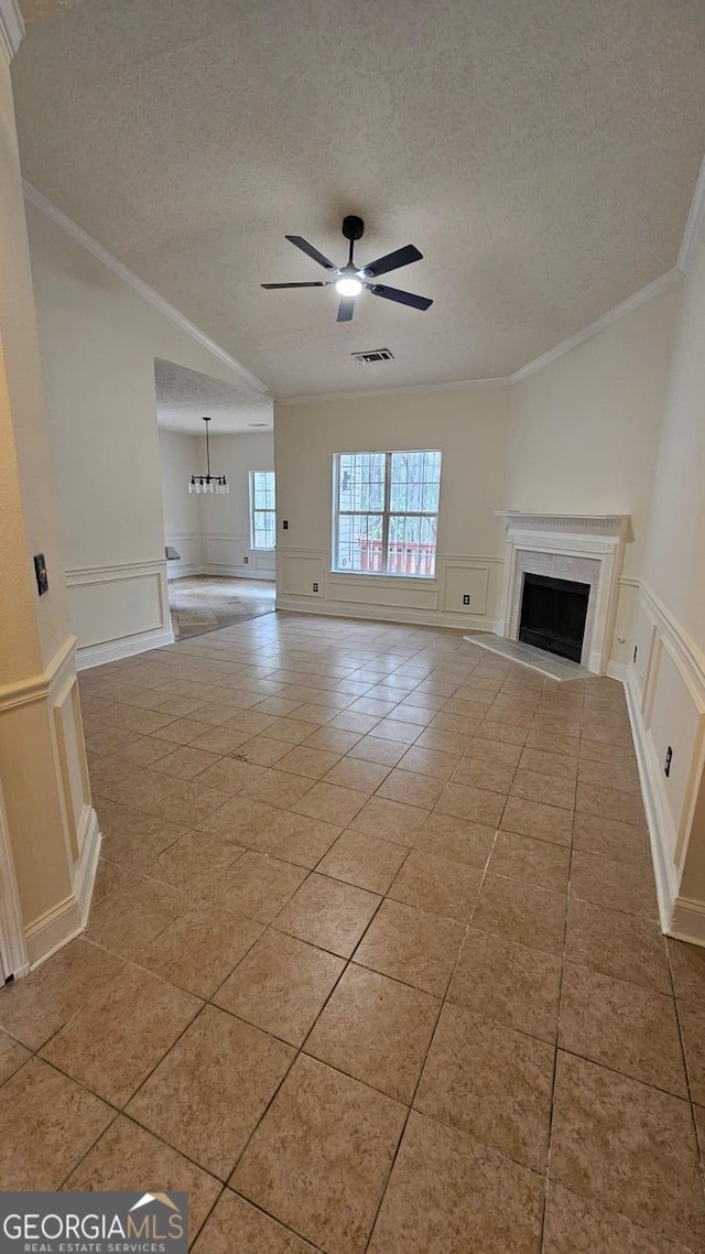 unfurnished living room with a decorative wall, a fireplace, and ceiling fan