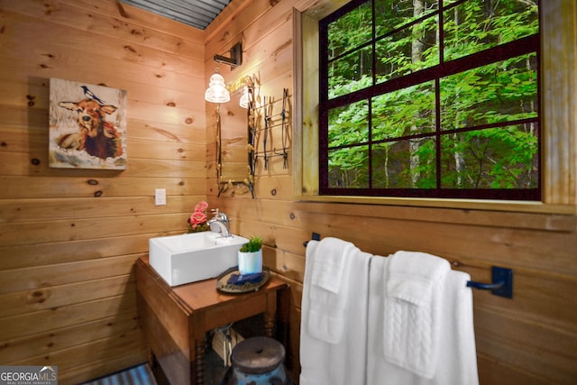 bathroom with wood walls and vanity