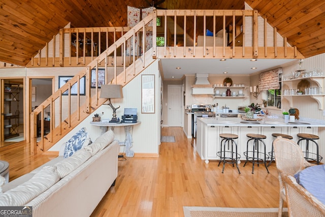 interior space featuring light countertops, wooden ceiling, open shelves, light wood finished floors, and stainless steel range with gas cooktop