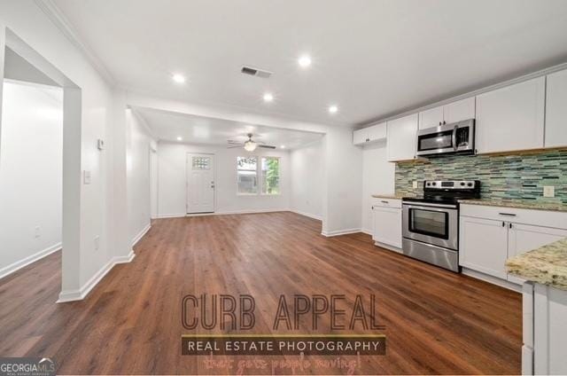 kitchen featuring white cabinets, visible vents, stainless steel appliances, and backsplash