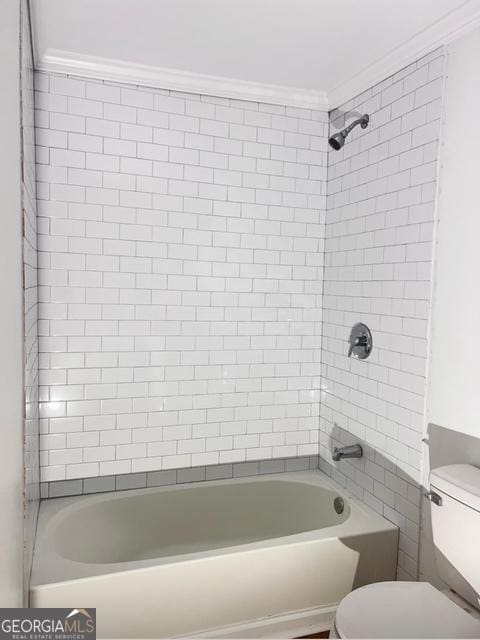 full bathroom featuring bathtub / shower combination, toilet, and ornamental molding