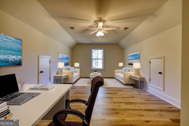 office area featuring visible vents, vaulted ceiling, light wood-style flooring, and ceiling fan