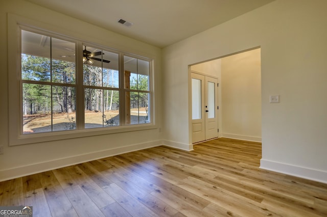 interior space with visible vents, baseboards, plenty of natural light, and hardwood / wood-style flooring