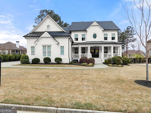 6635 Canyon Cv, Cumming, GA 30028 - modern farmhouse style home featuring a front yard, a standing seam roof, and covered porch