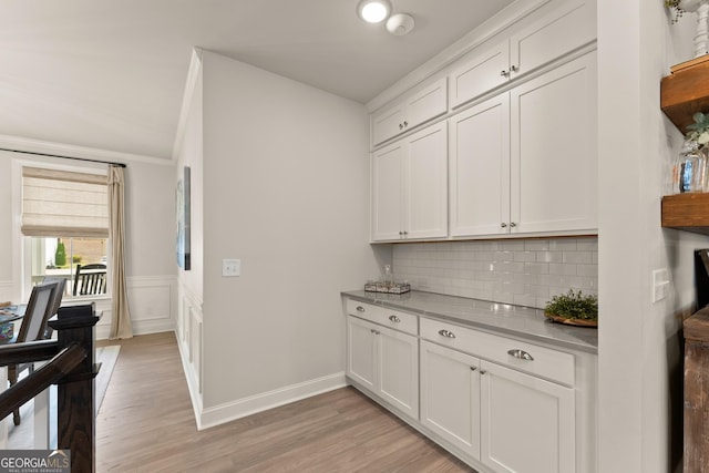 6635 Canyon Cv, Cumming, GA 30028 - bar featuring light wood-style floors, ornamental molding, baseboards, and decorative backsplash