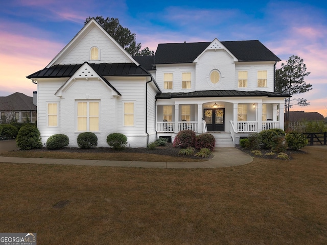 6635 Canyon Cv, Cumming, GA 30028 - modern inspired farmhouse with a porch, a standing seam roof, a yard, and metal roof
