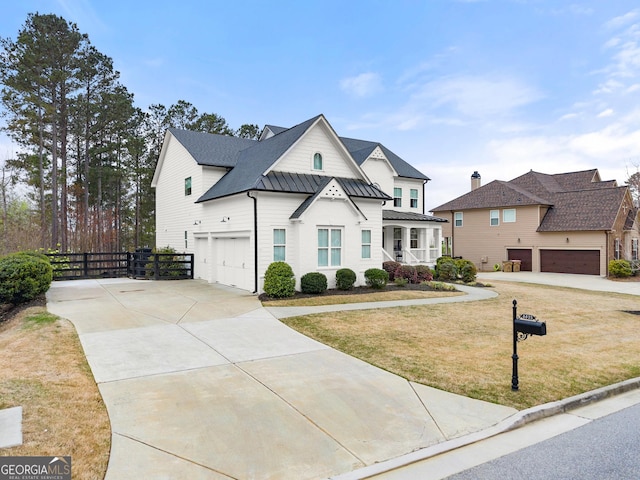 6635 Canyon Cv, Cumming, GA 30028 - view of front of house with concrete driveway, a front lawn, fence, metal roof, and a standing seam roof