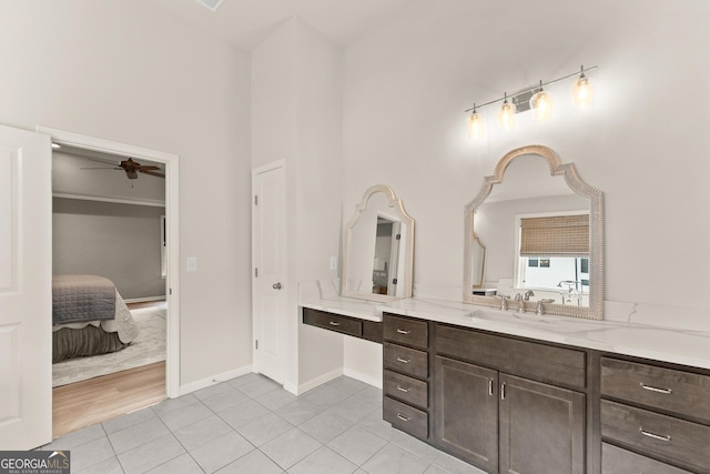 6635 Canyon Cv, Cumming, GA 30028 - ensuite bathroom with tile patterned floors, baseboards, ceiling fan, vanity, and connected bathroom