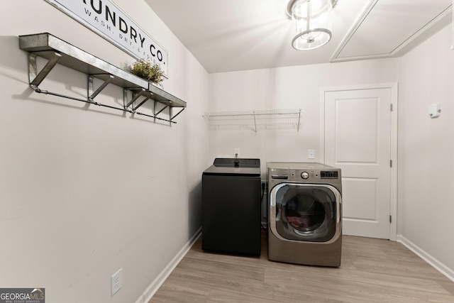 6635 Canyon Cv, Cumming, GA 30028 - clothes washing area with attic access, washing machine and dryer, baseboards, light wood-style floors, and laundry area
