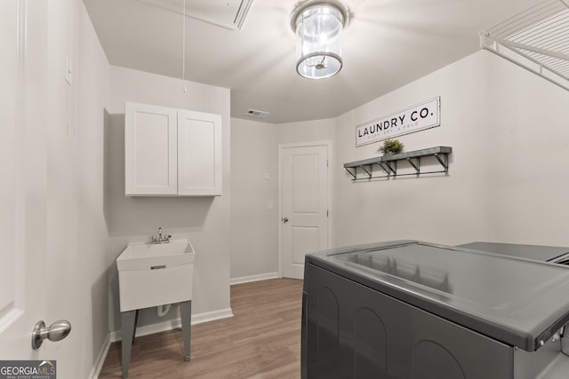 6635 Canyon Cv, Cumming, GA 30028 - clothes washing area with attic access, baseboards, visible vents, light wood-style floors, and laundry area