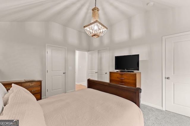 6635 Canyon Cv, Cumming, GA 30028 - carpeted bedroom with baseboards, an inviting chandelier, and high vaulted ceiling