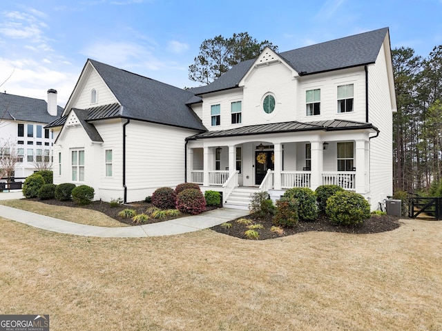 6635 Canyon Cv, Cumming, GA 30028 - modern inspired farmhouse with a porch, a standing seam roof, a front lawn, and roof with shingles
