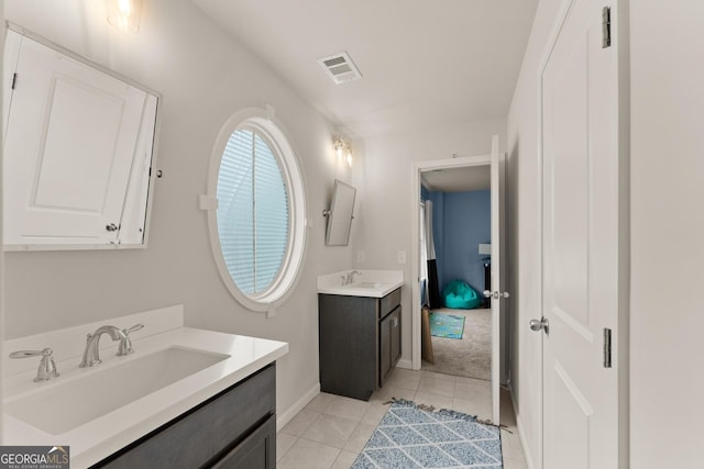 6635 Canyon Cv, Cumming, GA 30028 - bathroom featuring two vanities, tile patterned floors, visible vents, and a sink
