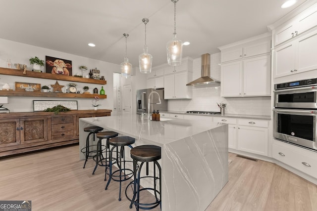 6635 Canyon Cv, Cumming, GA 30028 - kitchen with a kitchen breakfast bar, a sink, wall chimney range hood, open shelves, and appliances with stainless steel finishes