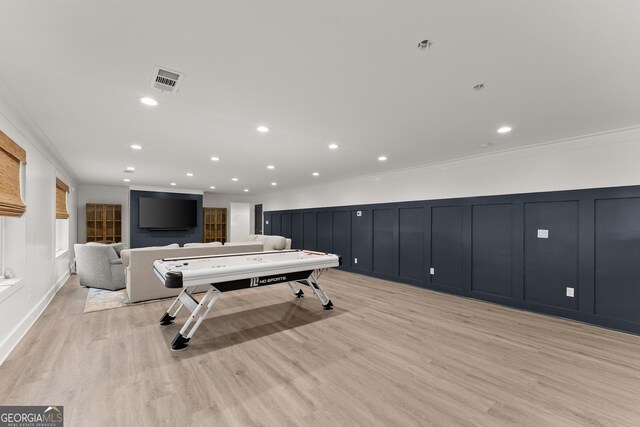 6635 Canyon Cv, Cumming, GA 30028 - recreation room with recessed lighting, a decorative wall, ornamental molding, and light wood-type flooring