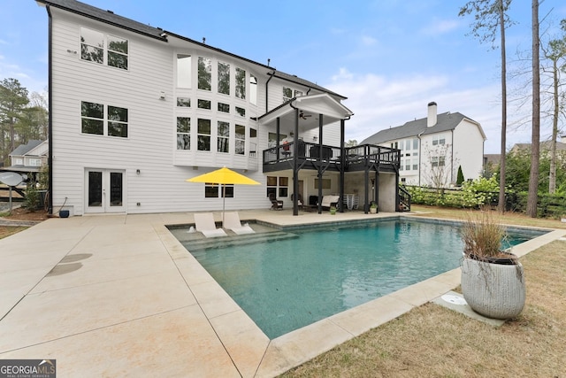 6635 Canyon Cv, Cumming, GA 30028 - back of property with an outdoor pool, a deck, french doors, and a patio