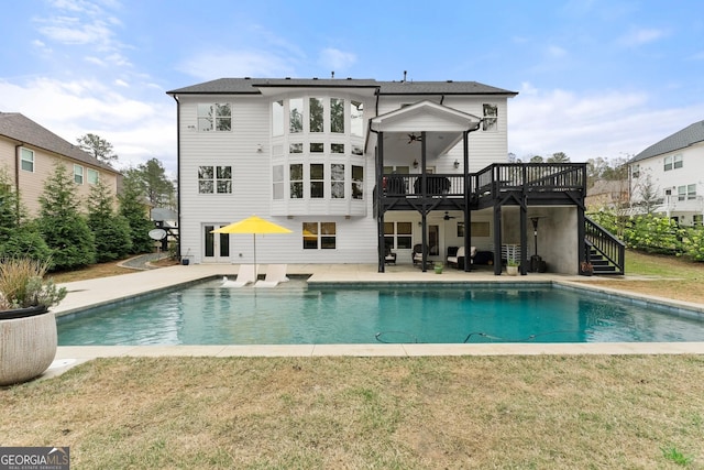6635 Canyon Cv, Cumming, GA 30028 - rear view of house featuring a lawn, an outdoor pool, stairway, and a deck