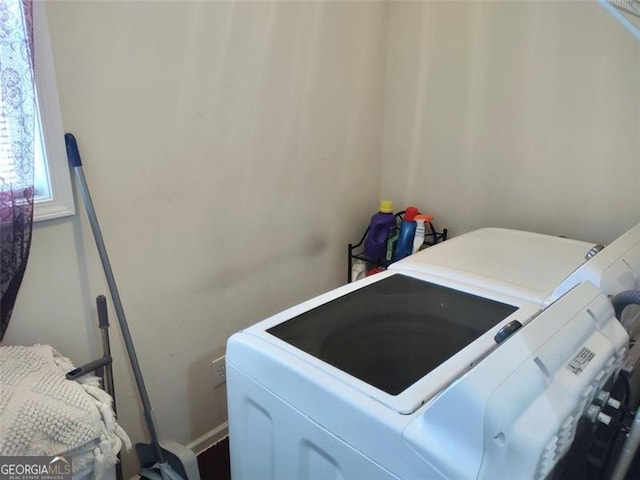clothes washing area featuring independent washer and dryer and laundry area