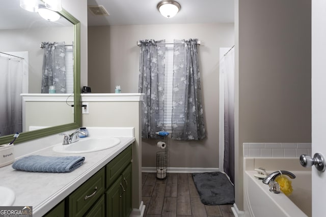 bedroom with baseboards, a textured ceiling, visible vents, and light wood-style flooring