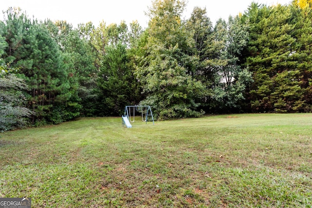 view of swimming pool featuring fence, a tennis court, and a lawn