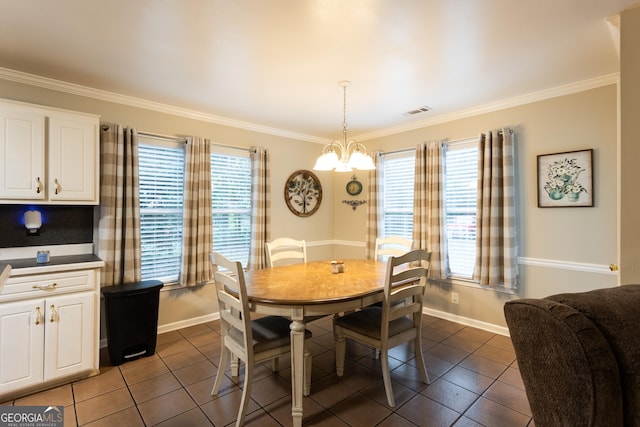 tiled dining space featuring visible vents, ornamental molding, baseboards, and ceiling fan with notable chandelier