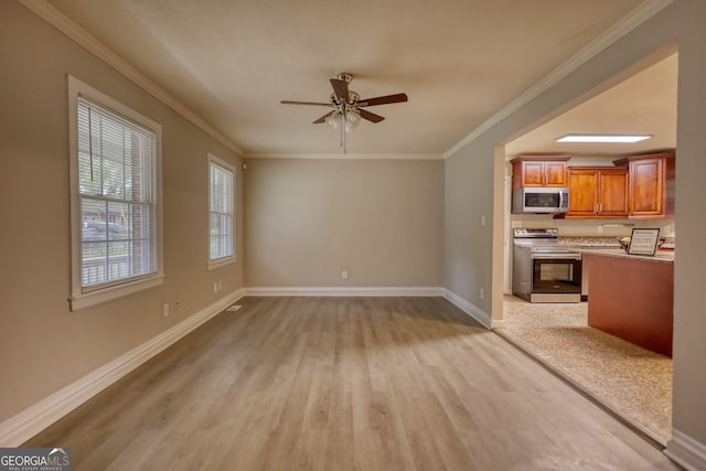 unfurnished living room featuring baseboards, light wood-type flooring, crown molding, and ceiling fan
