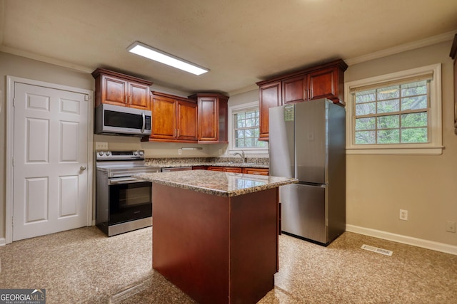 kitchen with a sink, ornamental molding, visible vents, and appliances with stainless steel finishes