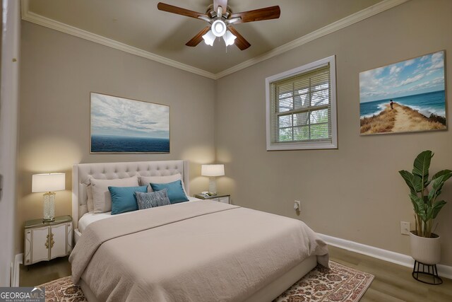 bedroom with ornamental molding, baseboards, ceiling fan, and wood finished floors