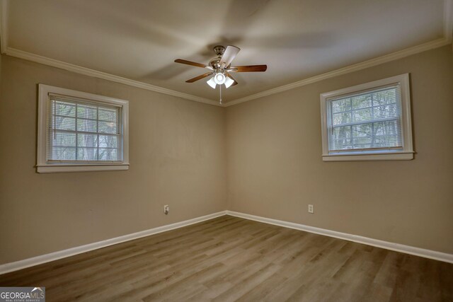 empty room featuring baseboards, crown molding, and a ceiling fan