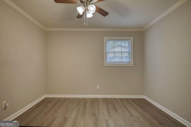 empty room with baseboards, ceiling fan, wood finished floors, and ornamental molding