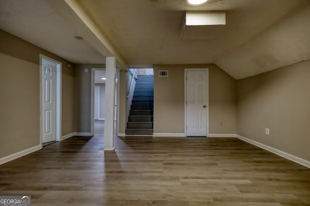 bonus room with baseboards, visible vents, and wood finished floors