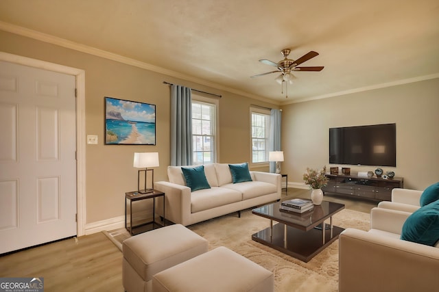 living room with a ceiling fan, crown molding, light wood-style floors, and baseboards