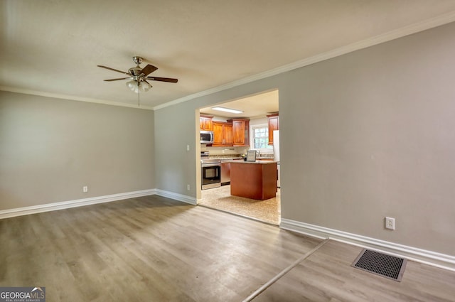 unfurnished living room featuring a ceiling fan, baseboards, light wood-style flooring, and visible vents